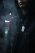 A silver metal dog tag necklace with a ball chain, featuring an engraved crosshair target and the word 'HUNTER' in a stylized font, shown on a plain white background.