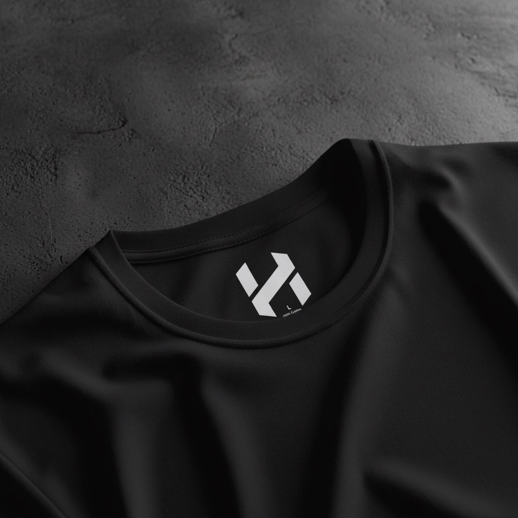 Black t-shirt with a white logo on the collar against a white background