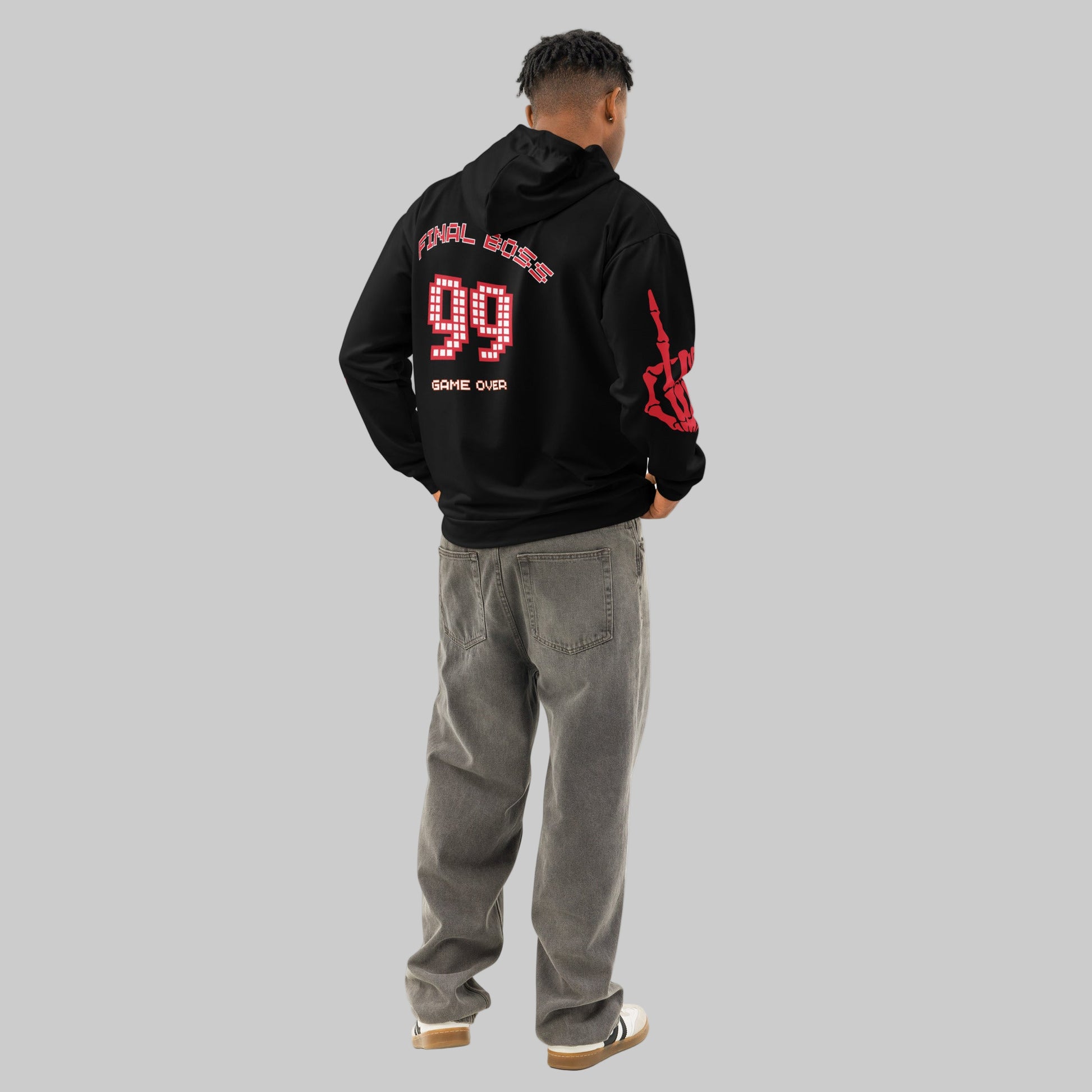 male model turning to show the back of the Gamer Hoodie, clearly displaying the large 'FINAL BOSS 99' graphic. The image emphasizes the drop shoulder and comfortable streetwear style.