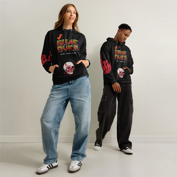 Male and female model wearing the 'Final Boss' Pixel Art Hoodie in a relaxed, unisex fit. The Dark Gaming Streetwear pullover features the 'GAME OVER' pixel font on the chest and a bold arcade skull graphic.