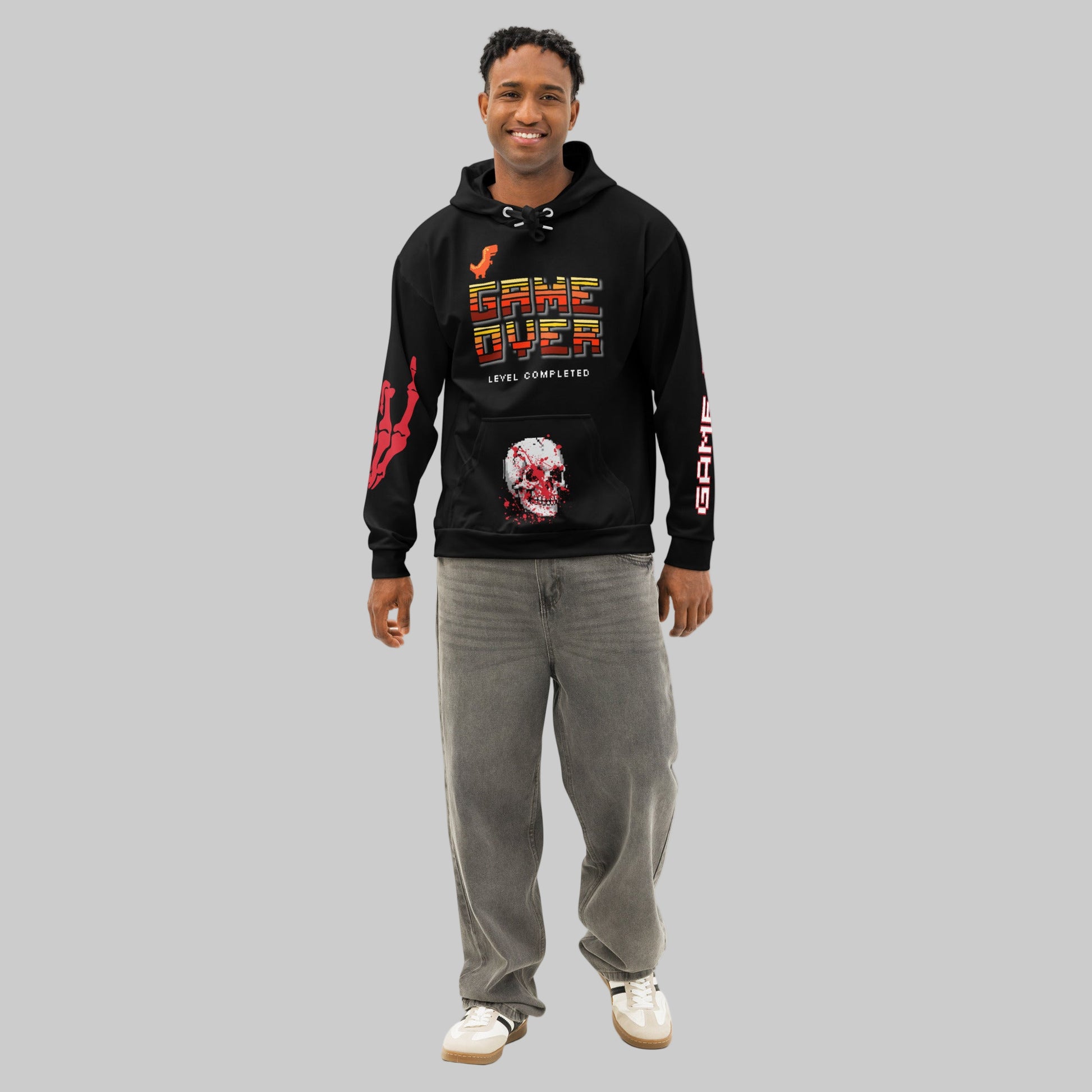 Male model wearing the 'Final Boss' Pixel Art Hoodie in a relaxed, unisex fit. The Dark Gaming Streetwear pullover features the 'GAME OVER' pixel font on the chest and a bold arcade skull graphic