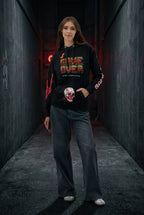 Model with hands in the spacious front pocket of the hoodie, highlighting the red skull and blood graphic detail. The image also captures the 'GAME OVER' sleeve text, reinforcing the Gothic Streetwear aesthetic.