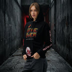 female model wearing the 'Final Boss' Pixel Art Hoodie in a relaxed, unisex fit. The Dark Gaming Streetwear pullover features the 'GAME OVER' pixel font on the chest and a bold arcade skull graphic.