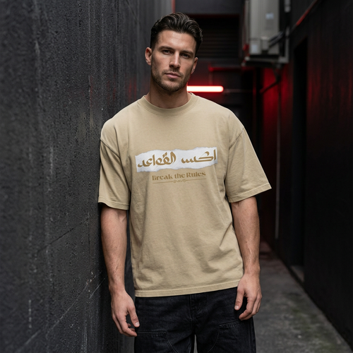 Faded Khaki model leaning against concrete wall
