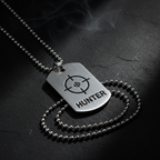 Hunter Crosshair Dog Tag Necklace stainless steel flat lay on dark matte surface with moody editorial lighting