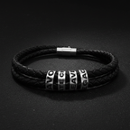 Double-wrap braided black leather bracelet with silver engraved beads reading HAVOC CREATE LEAVE LEGACY on dark matte background