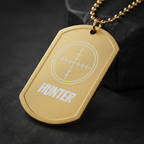 Gold plated Hunter Crosshair Dog Tag Necklace close-up macro shot with warm golden light on dark background