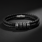 Close-up of silver stainless steel engraved beads on double-wrap black leather bracelet with dramatic moody lighting
