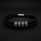 Double-wrap braided black leather bracelet with silver engraved beads reading HUNTER PATIENCE PRECISION PURSUIT on dark matte background